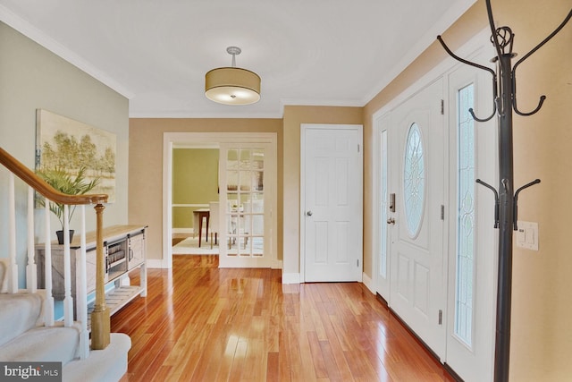 6034 Burnside Landing Dr, Burke, VA 22015 - entrance foyer with crown molding, stairs, light wood finished floors, and baseboards