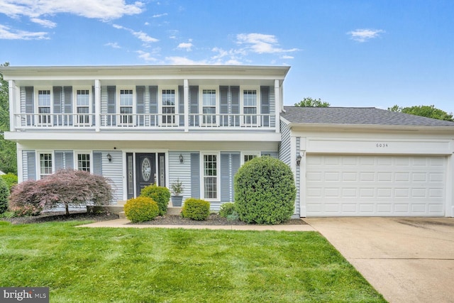 6034 Burnside Landing Dr, Burke, VA 22015 - view of front of house featuring a balcony, a front yard, concrete driveway, and a garage