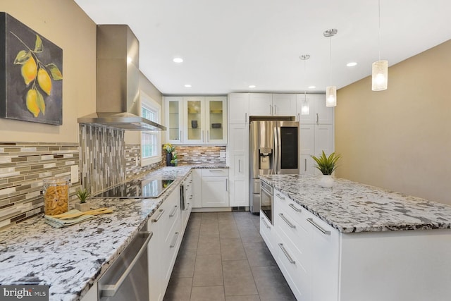 6034 Burnside Landing Dr, Burke, VA 22015 - kitchen featuring exhaust hood, appliances with stainless steel finishes, a center island, dark tile patterned floors, and decorative backsplash