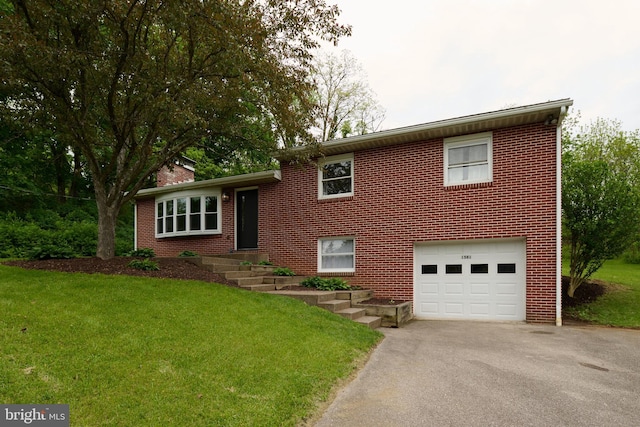 1581 W Branch Rd, State College, PA 16801 - split level home with asphalt driveway, a garage, a front yard, and brick siding