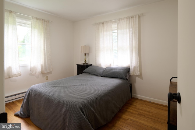 1581 W Branch Rd, State College, PA 16801 - bedroom featuring a baseboard heating unit, wood finished floors, and baseboards
