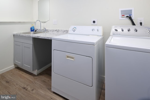1581 W Branch Rd, State College, PA 16801 - washroom with washing machine and clothes dryer, wood finished floors, and cabinet space