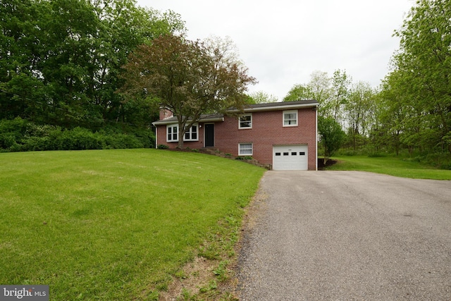 1581 W Branch Rd, State College, PA 16801 - split level home featuring driveway, a chimney, an attached garage, a front lawn, and brick siding