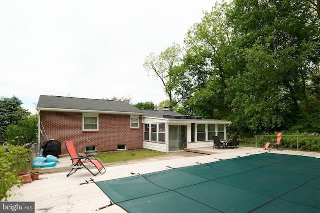 1581 W Branch Rd, State College, PA 16801 - back of house featuring a wooden deck, brick siding, and a sunroom