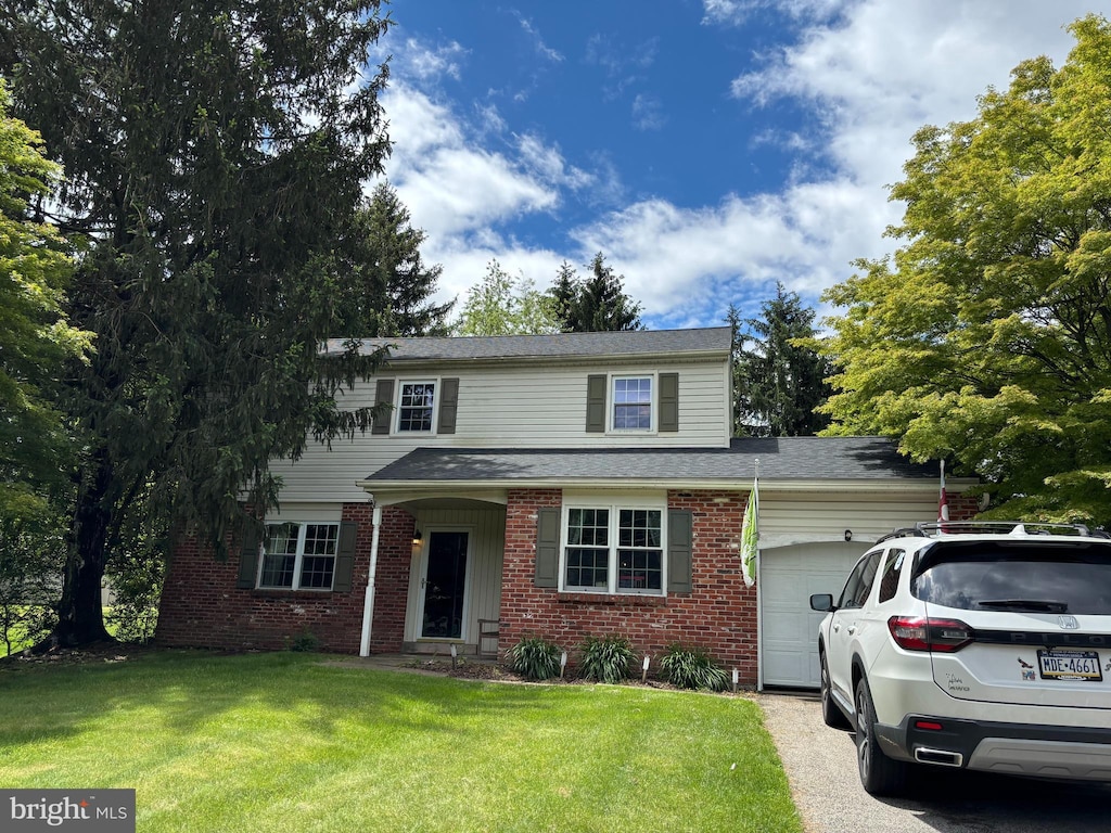 408 W Bristol Rd, Southampton, PA 18966 - traditional-style house featuring an attached garage, brick siding, a front yard, and driveway