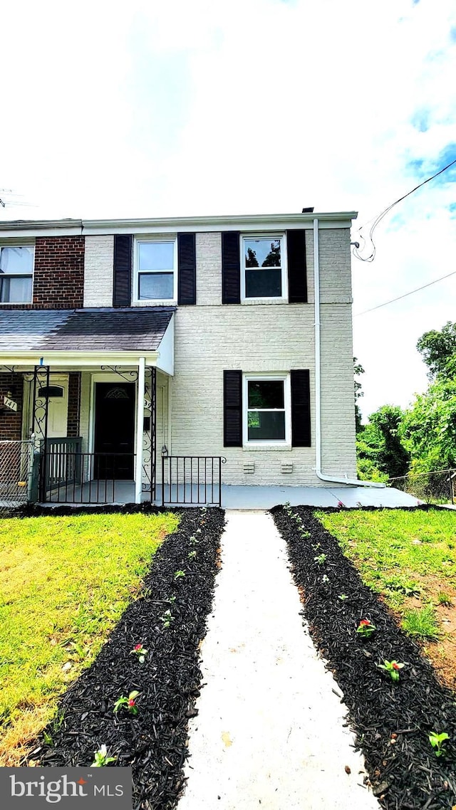 139 Wilmington Pl SE, Washington, DC 20032 - view of front of property featuring brick siding, a front lawn, and covered porch