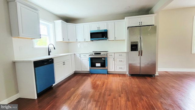 139 Wilmington Pl SE, Washington, DC 20032 - kitchen featuring stainless steel appliances, dark wood-style flooring, a sink, white cabinetry, and light countertops