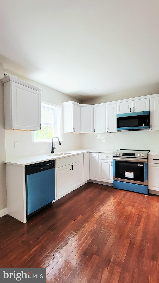 139 Wilmington Pl SE, Washington, DC 20032 - kitchen featuring appliances with stainless steel finishes, dark wood-style flooring, light countertops, and a sink