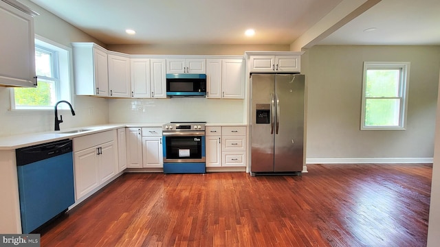 139 Wilmington Pl SE, Washington, DC 20032 - kitchen with appliances with stainless steel finishes, dark wood-type flooring, white cabinetry, and recessed lighting