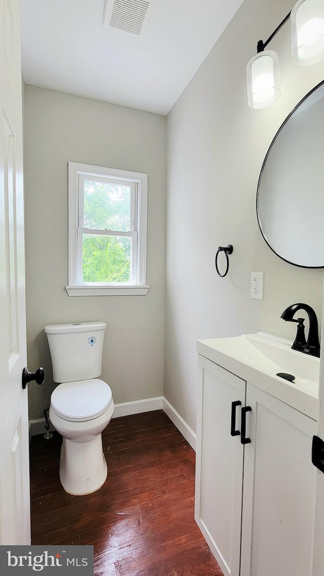 139 Wilmington Pl SE, Washington, DC 20032 - bathroom featuring vanity, wood finished floors, toilet, and baseboards
