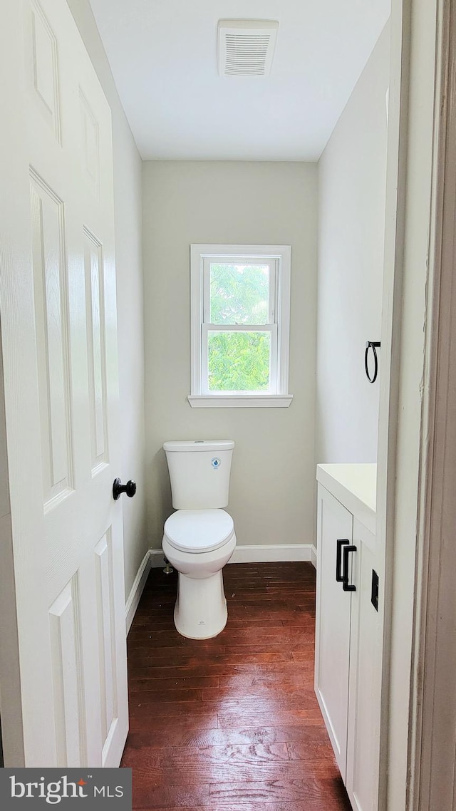 139 Wilmington Pl SE, Washington, DC 20032 - half bath with vanity, toilet, wood finished floors, and baseboards