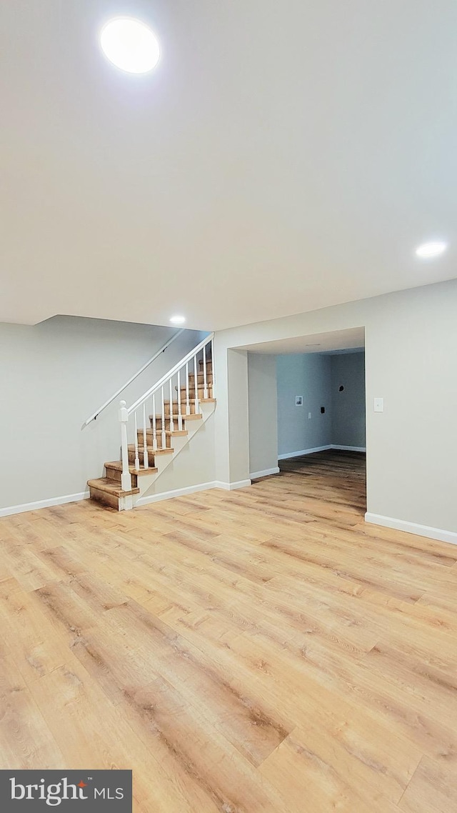 139 Wilmington Pl SE, Washington, DC 20032 - unfurnished living room featuring wood finished floors, baseboards, and stairs