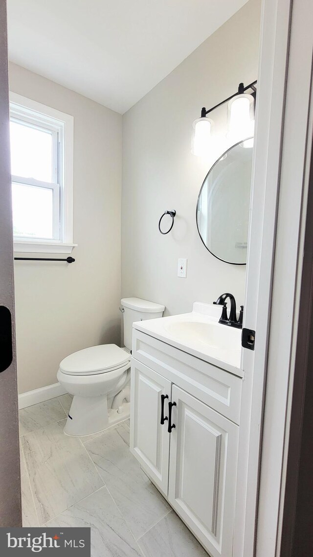 139 Wilmington Pl SE, Washington, DC 20032 - bathroom featuring marble look tile flooring, vanity, and toilet