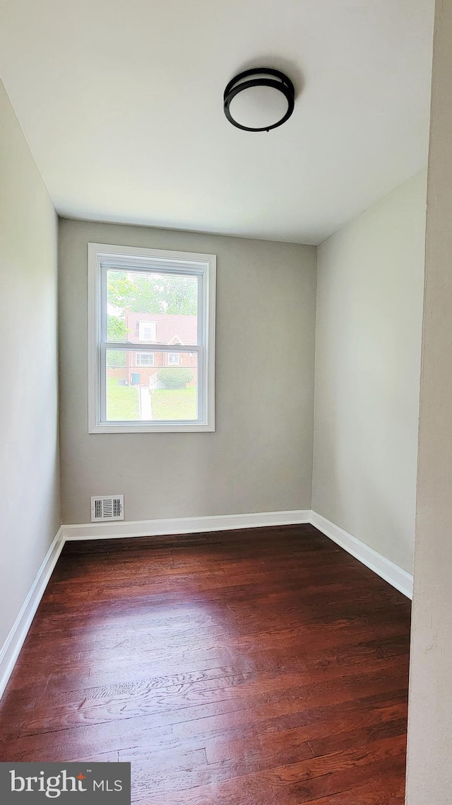 139 Wilmington Pl SE, Washington, DC 20032 - empty room with dark wood-style floors and baseboards