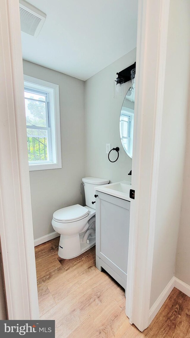 139 Wilmington Pl SE, Washington, DC 20032 - half bath with vanity, wood finished floors, toilet, and baseboards