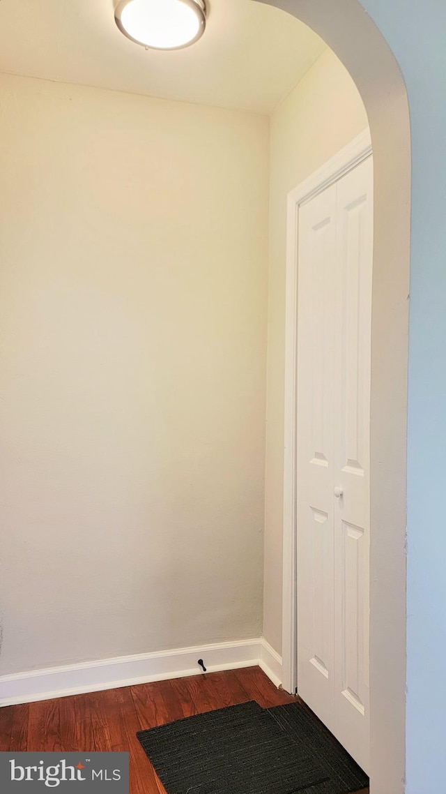 139 Wilmington Pl SE, Washington, DC 20032 - hallway with arched walkways, wood finished floors, and baseboards