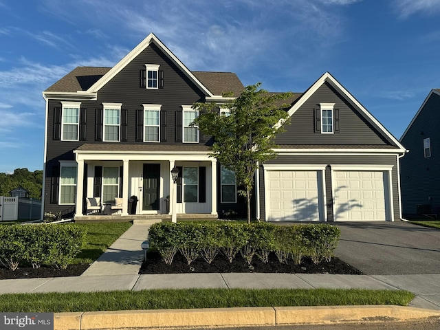 220 Moorefield St, Mechanicsburg, PA 17055 - view of front of home featuring driveway, covered porch, and a garage