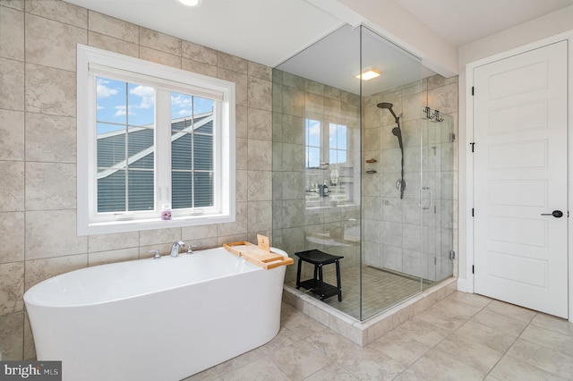 220 Moorefield St, Mechanicsburg, PA 17055 - bathroom featuring tile walls, a shower stall, a soaking tub, and tile patterned floors