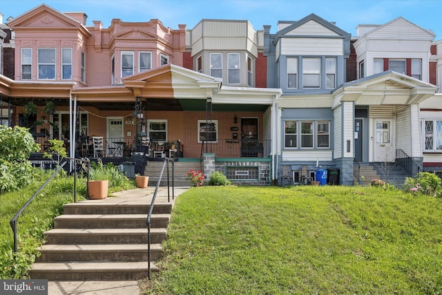 5324 Cedar Ave, Philadelphia, PA 19143 - townhome / multi-family property with a front yard and a porch
