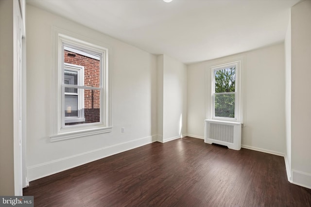 5324 Cedar Ave, Philadelphia, PA 19143 - unfurnished room featuring radiator heating unit, dark wood-style floors, and baseboards