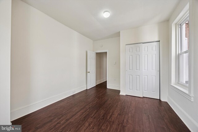 5324 Cedar Ave, Philadelphia, PA 19143 - unfurnished bedroom with dark wood-style flooring, multiple windows, and baseboards