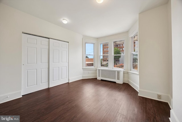 5324 Cedar Ave, Philadelphia, PA 19143 - unfurnished bedroom with radiator, wood finished floors, and baseboards