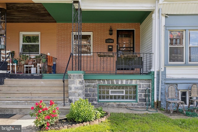 5324 Cedar Ave, Philadelphia, PA 19143 - doorway to property featuring covered porch and brick siding