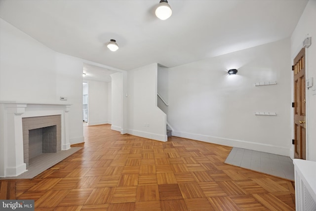 5324 Cedar Ave, Philadelphia, PA 19143 - unfurnished living room with baseboards, a fireplace, and stairs