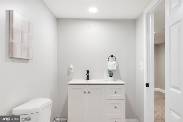 1202 Dukeland St, Baltimore, MD 21216 - half bathroom with toilet, vanity, baseboards, and recessed lighting