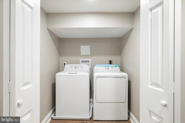 1202 Dukeland St, Baltimore, MD 21216 - washroom with separate washer and dryer, baseboards, and wood finished floors
