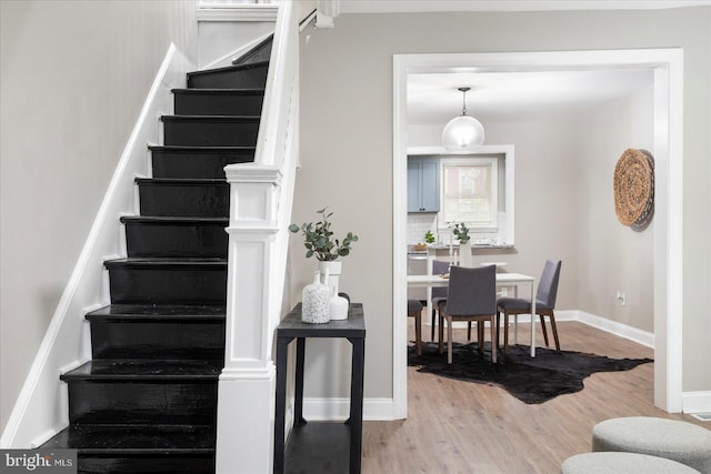 1202 Dukeland St, Baltimore, MD 21216 - stairs featuring wood finished floors and baseboards