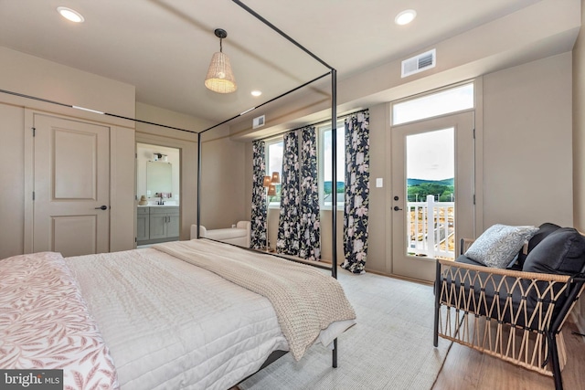 714 Iron Frg Unit A, Frederick, MD 21702 - bedroom with multiple windows, access to exterior, recessed lighting, and light wood-style flooring