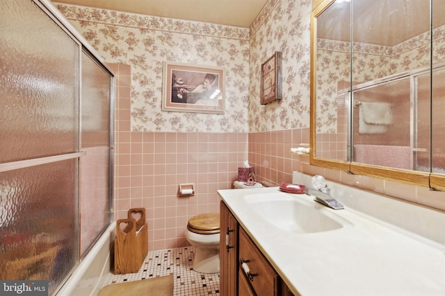 2453 Lincoln Hwy E, Lancaster, PA 17602 - bathroom featuring wallpapered walls, vanity, toilet, tile walls, and wainscoting