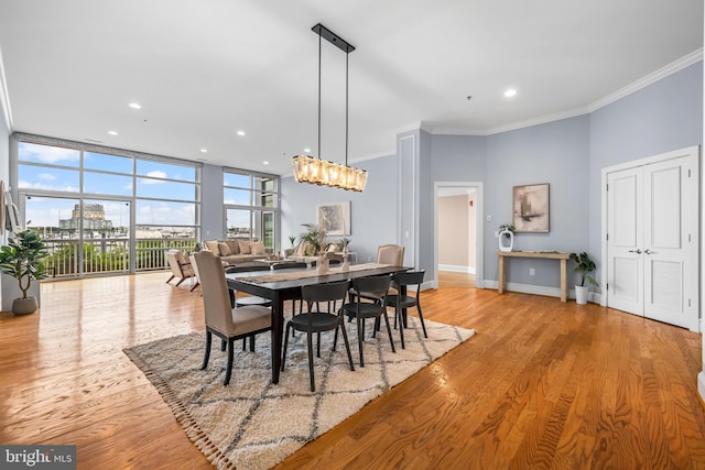 2772 Lighthouse Pt E Unit 101, Baltimore, MD 21224 - dining area with ornamental molding, wood finished floors, baseboards, recessed lighting, and a chandelier