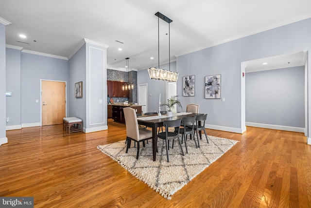 2772 Lighthouse Pt E Unit 101, Baltimore, MD 21224 - dining space with crown molding, wood finished floors, a chandelier, baseboards, and recessed lighting