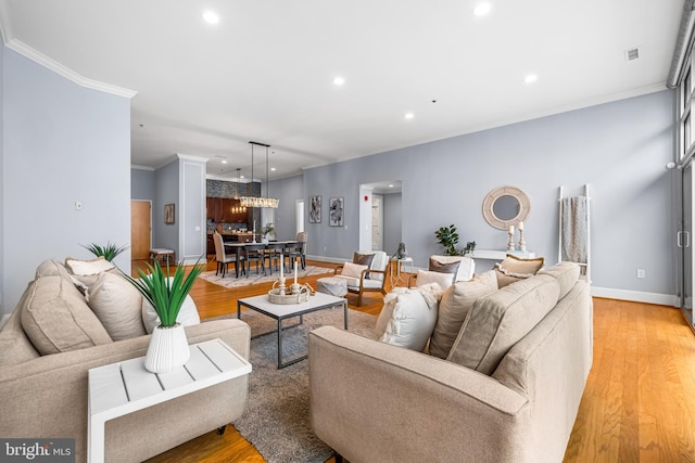 2772 Lighthouse Pt E Unit 101, Baltimore, MD 21224 - living room featuring ornamental molding, recessed lighting, light wood-type flooring, and baseboards