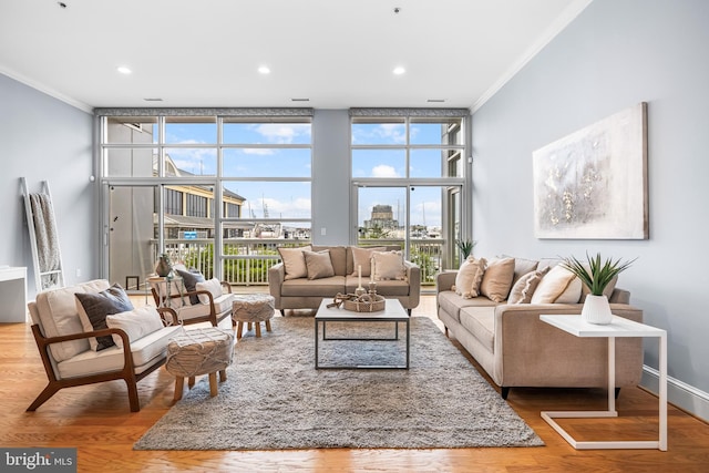 2772 Lighthouse Pt E Unit 101, Baltimore, MD 21224 - living room with ornamental molding, floor to ceiling windows, wood finished floors, healthy amount of natural light, and recessed lighting