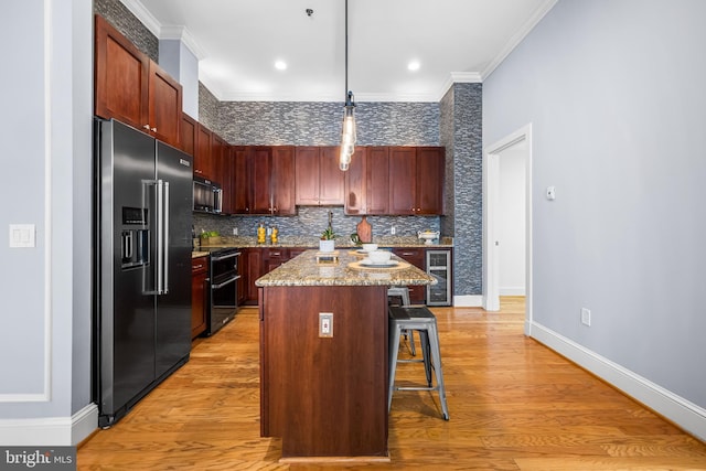 2772 Lighthouse Pt E Unit 101, Baltimore, MD 21224 - kitchen with high quality fridge, black microwave, double oven range, wine cooler, and a breakfast bar