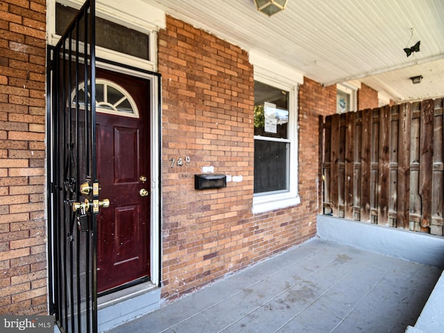 749 Bartlett Ave, Baltimore, MD 21218 - view of exterior entry featuring brick siding and a porch