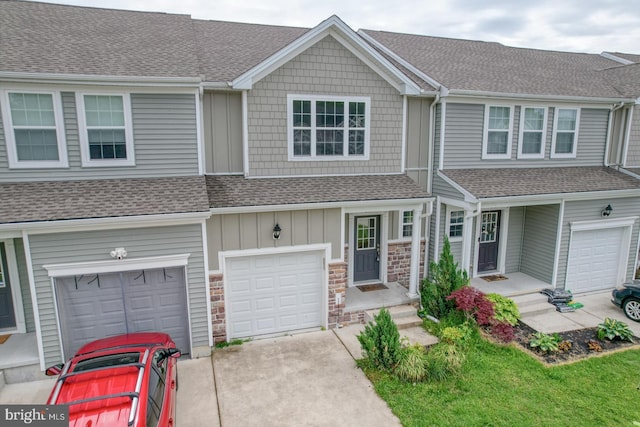 217 Tea Party Trl, Dover, DE 19901 - townhome / multi-family property with roof with shingles, concrete driveway, an attached garage, and stone siding