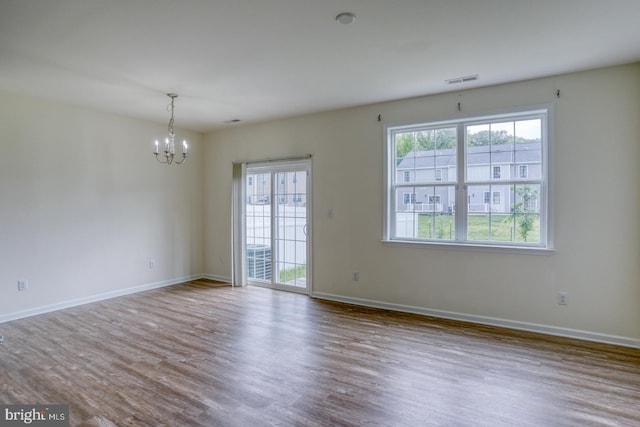 217 Tea Party Trl, Dover, DE 19901 - spare room with healthy amount of natural light, a chandelier, wood finished floors, and baseboards