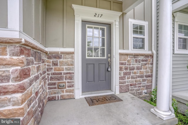 217 Tea Party Trl, Dover, DE 19901 - doorway to property with board and batten siding and covered porch