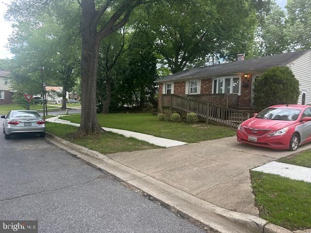 7507 Vanessa Ct, Lanham, MD 20706 - ranch-style house with a front yard, brick siding, and a chimney