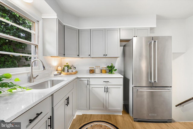 8511 Valleyfield Rd, Lutherville Timonium, MD 21093 - kitchen featuring freestanding refrigerator, a sink, light wood finished floors, and light stone counters