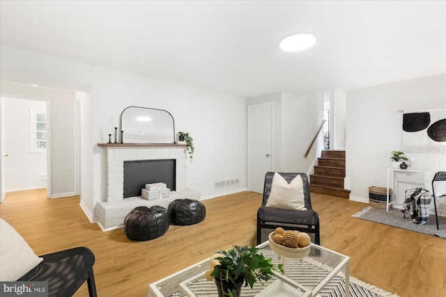 8511 Valleyfield Rd, Lutherville Timonium, MD 21093 - living area featuring stairs, wood finished floors, a fireplace, and baseboards