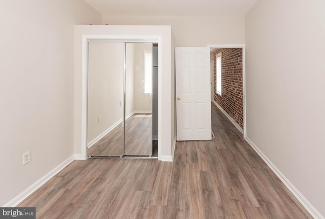 3808 Mount Pleasant Ave, Baltimore, MD 21224 - unfurnished bedroom featuring wood finished floors, baseboards, and a closet