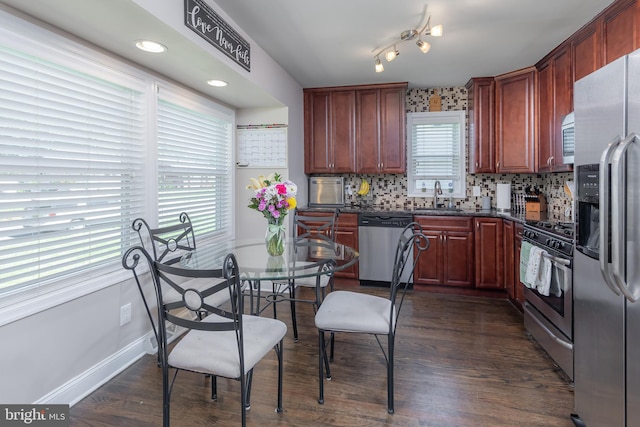 734 Shields, West Deptford, NJ 08096 - kitchen featuring appliances with stainless steel finishes, dark countertops, backsplash, baseboards, and a sink