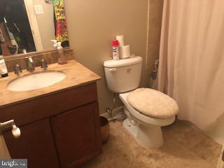 2656 15th St NW Unit C4, Washington, DC 20009 - bathroom featuring vanity, toilet, and curtained shower