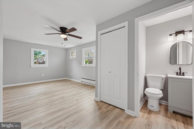 732 Thorndale Rd, Aldan, PA 19018 - unfurnished bedroom with a sink, a baseboard heating unit, light wood-style floors, a closet, and baseboards