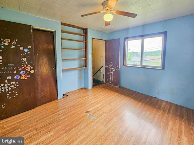 197 Coates Way, Fayette City, PA 15438 - unfurnished bedroom featuring wood finished floors, a closet, and a ceiling fan